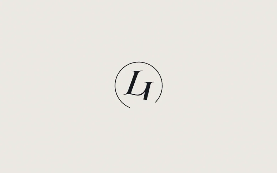 The LJ monogram being drawn in a thin ring on a warm off-white page during the intro.